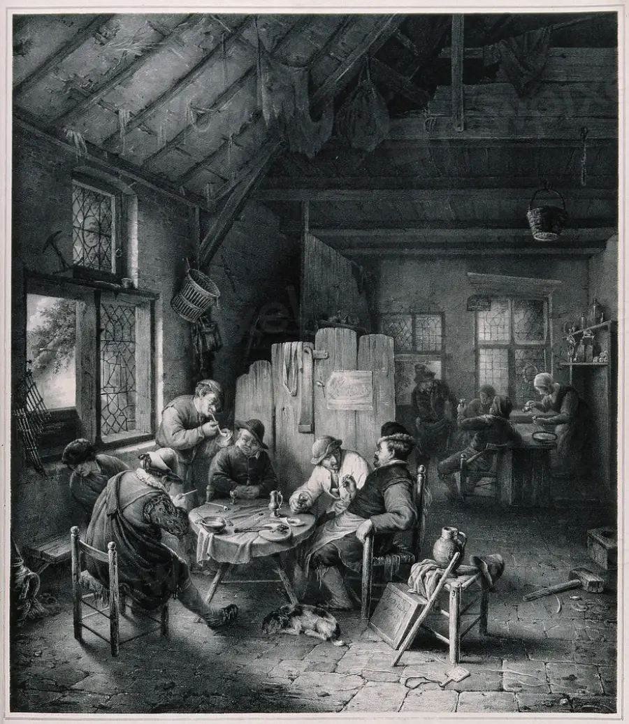 A group of people sit around a table eating in a rustic, cluttered room with exposed beams. Sunlight streams through a window, and others are busy in the background.