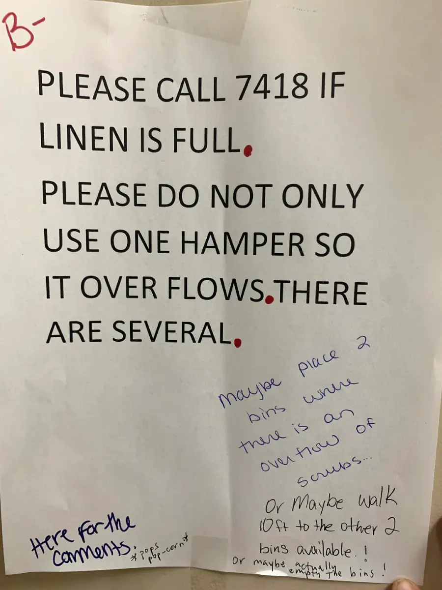 A typed sign about using several hampers for linens has handwritten notes suggesting placing more bins where needed and walking to other bins. “Here for the comments:” is also written with arrows pointing to the notes.