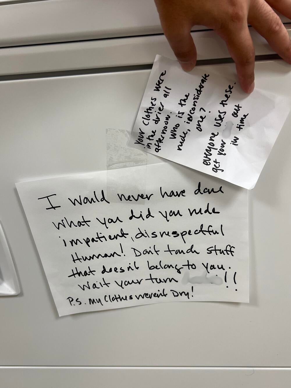 Two handwritten notes: one held by a hand, another taped to a surface. The notes express frustration over someone moving another person’s laundry, with messages about respect and patience.