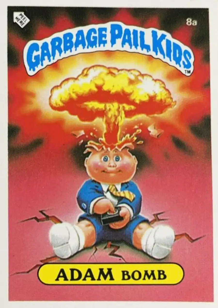 A cartoon boy in a suit sits with a mushroom cloud explosion coming out of his head. The card reads “Garbage Pail Kids” at the top and “Adam Bomb” at the bottom.