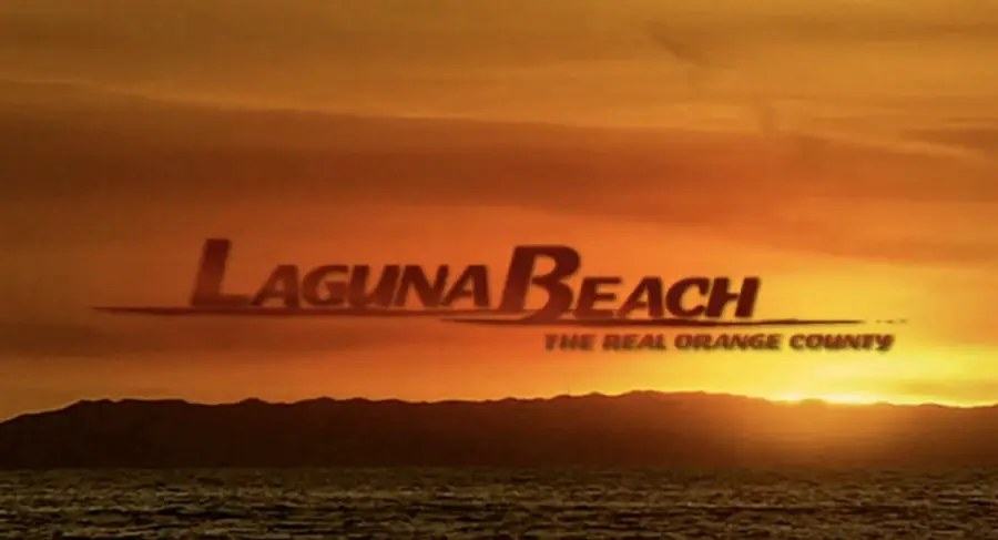 Laguna Beach: The Real Orange County logo appears over a sunset, with the ocean and a silhouetted coastline visible below the glowing orange sky.