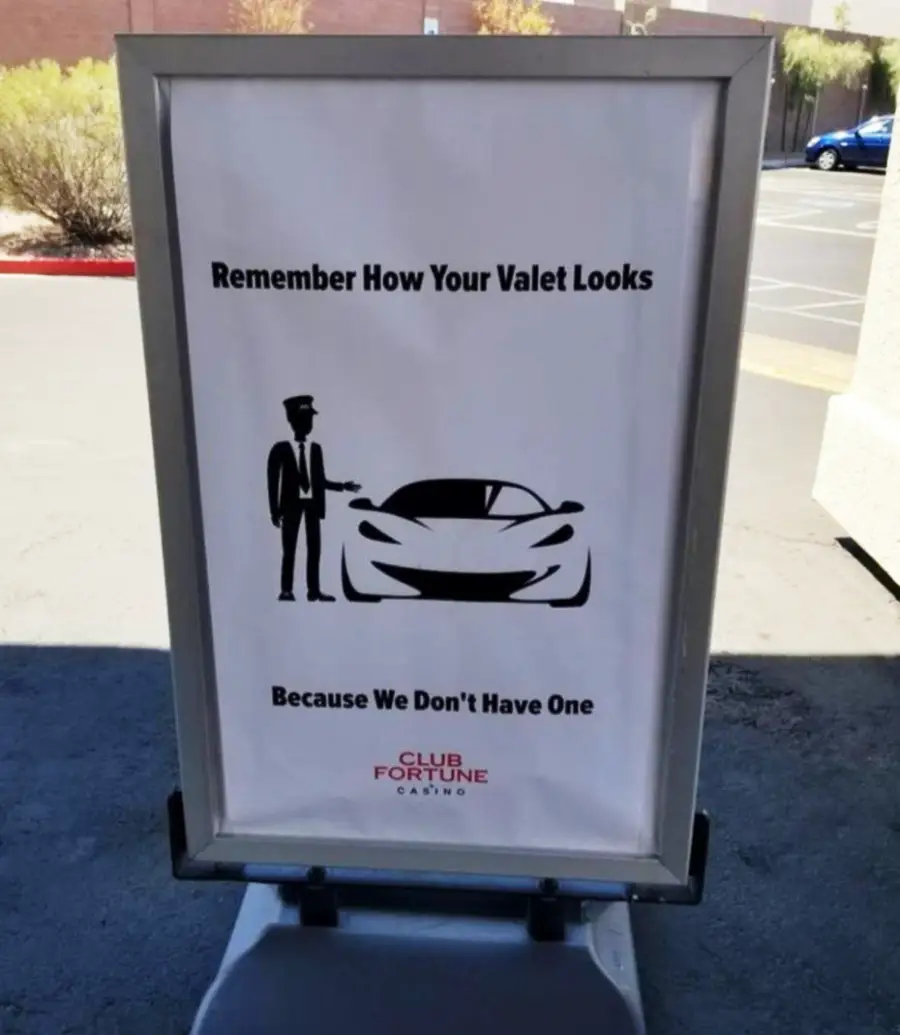 A sign with a car and valet icon reads, “Remember How Your Valet Looks Because We Don’t Have One,” promoting self-parking at Club Fortune Casino.