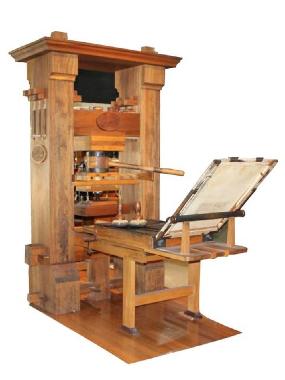 A vintage wooden printing press with a hinged frame and ink rollers.