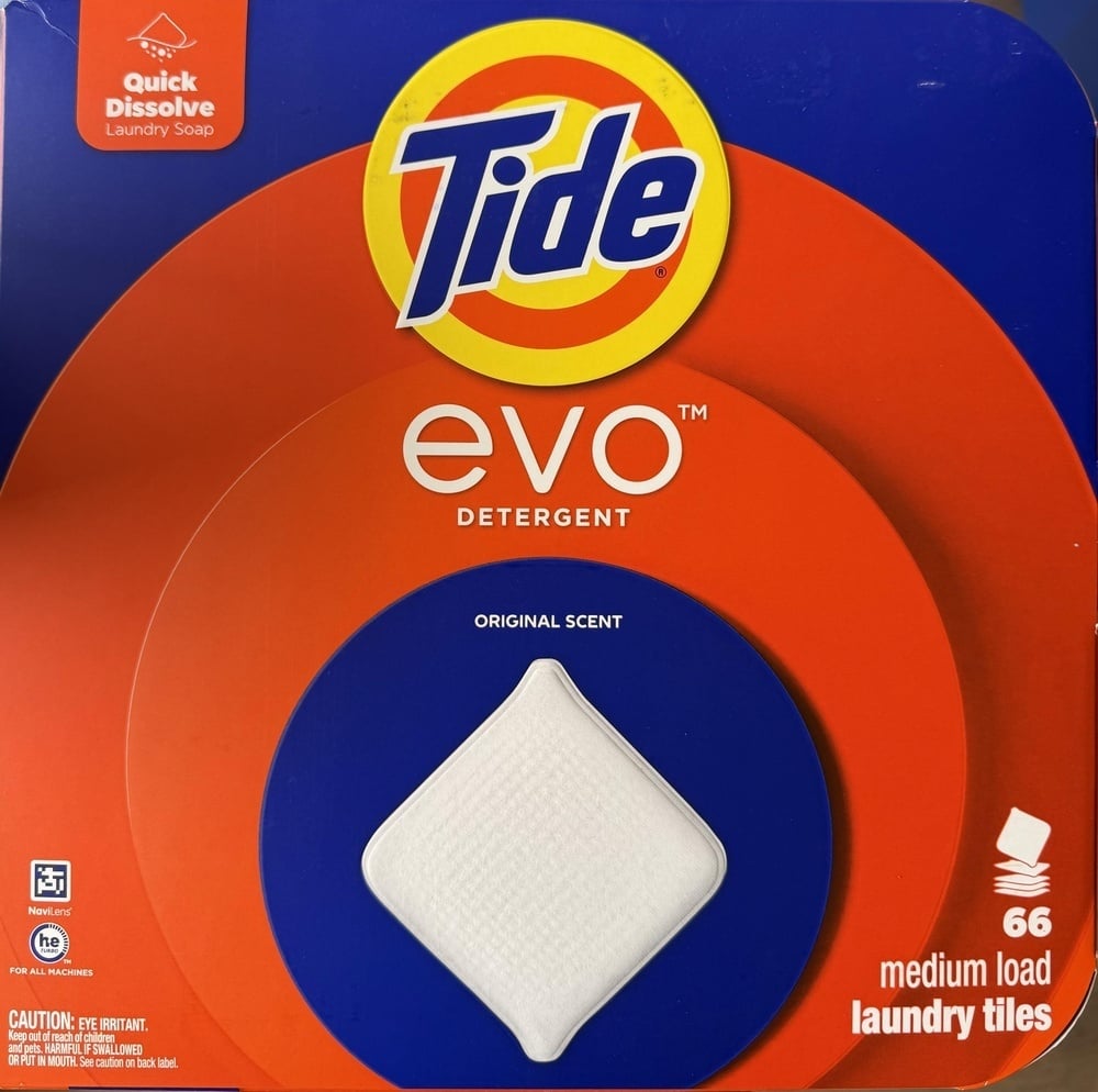 A package of Tide Evo laundry detergent tiles, featuring a white detergent tile at the center and text indicating 66 medium load tiles.