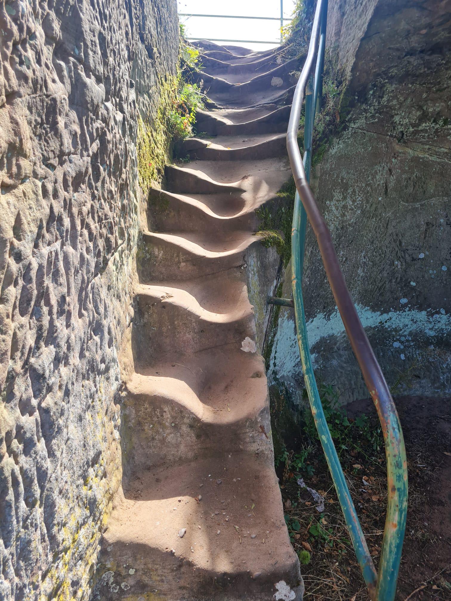 Old stone steps worn into smooth depressions by generations of footsteps.