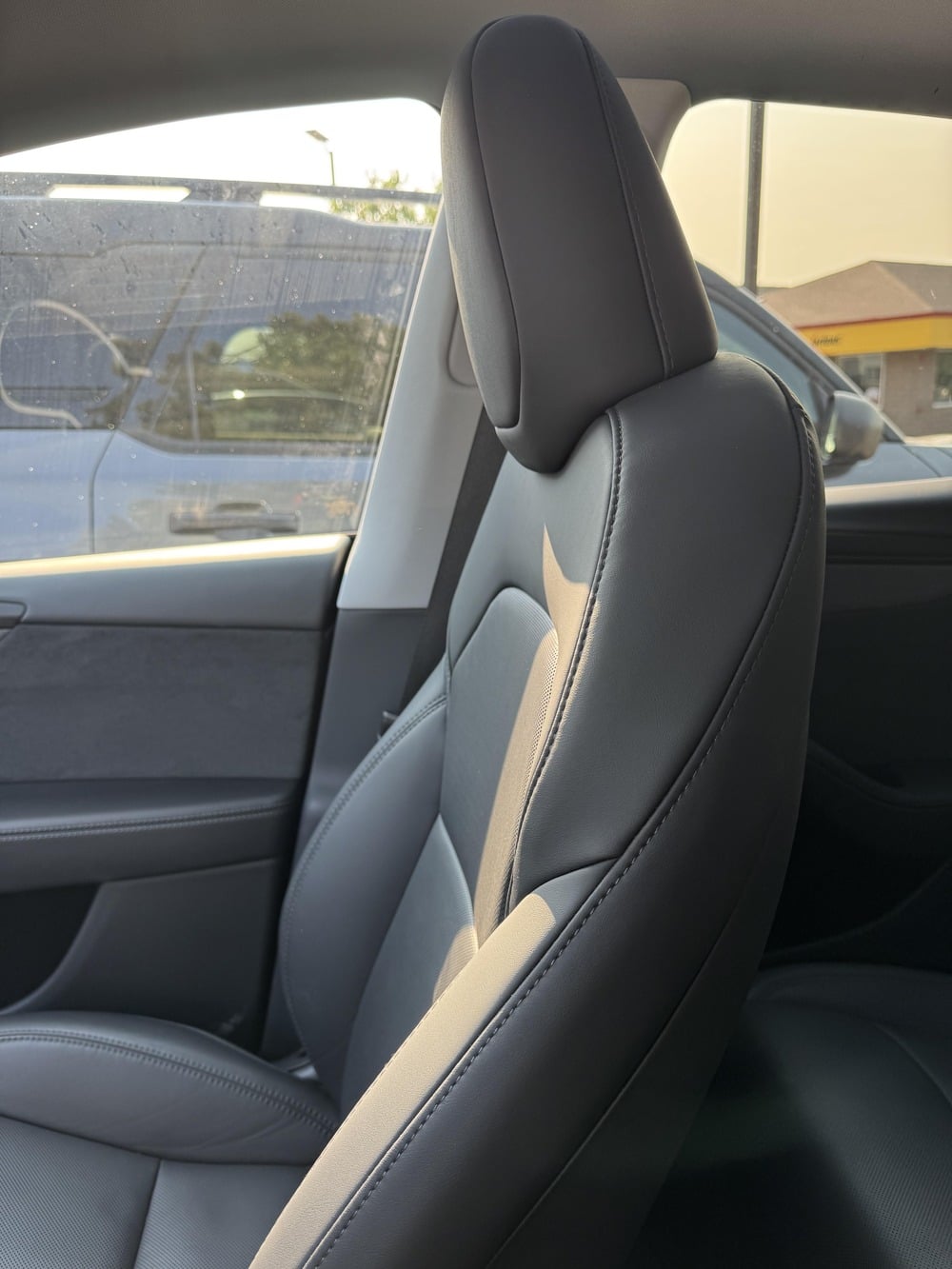 Dark gray leather car seat inside a vehicle cabin.
