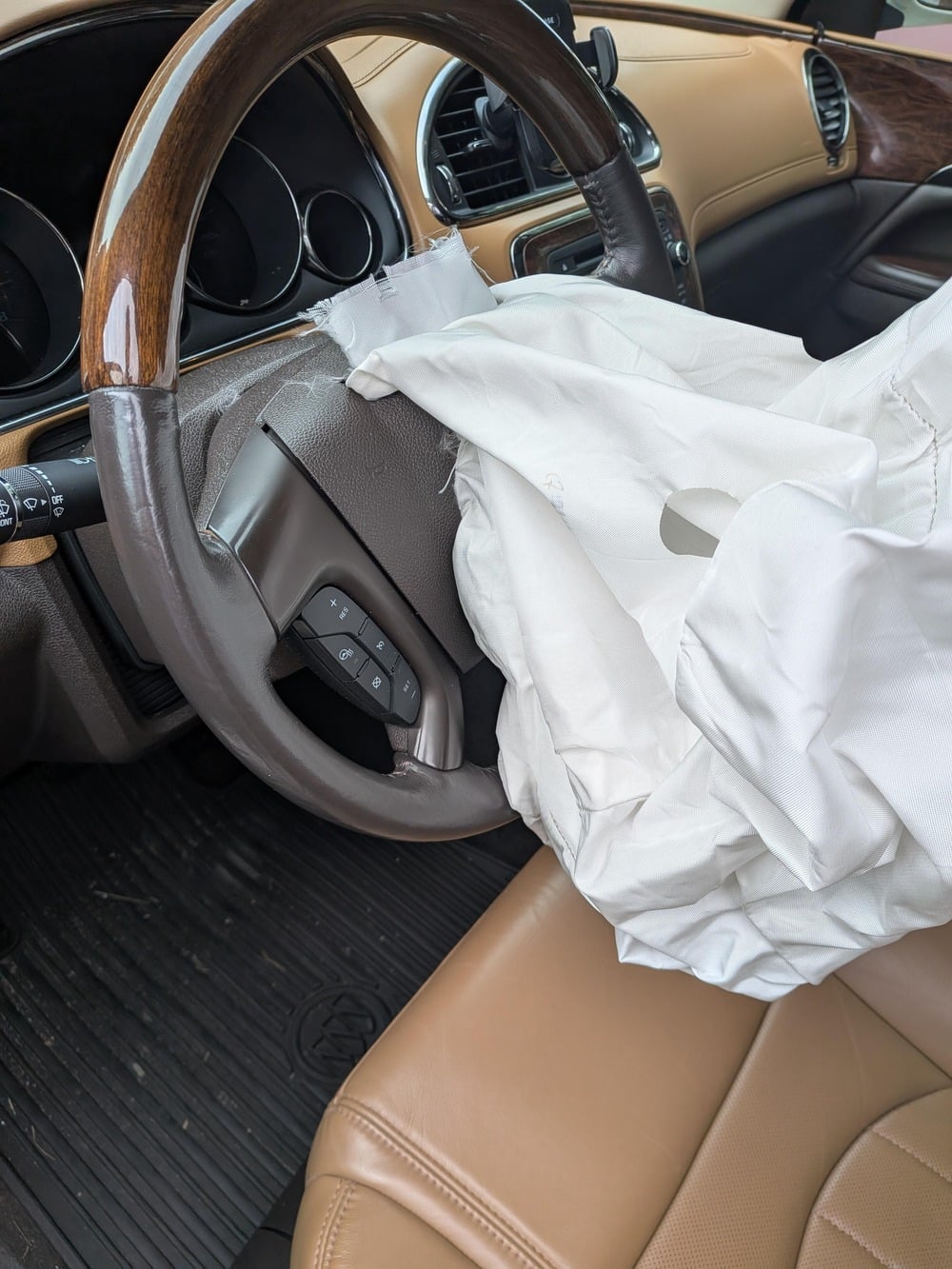 A deployed driver-side airbag over the steering wheel of a car.