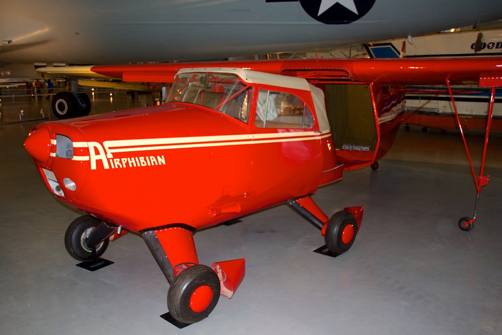 Bright red Fulton Airphibian roadable aircraft on display in a museum.