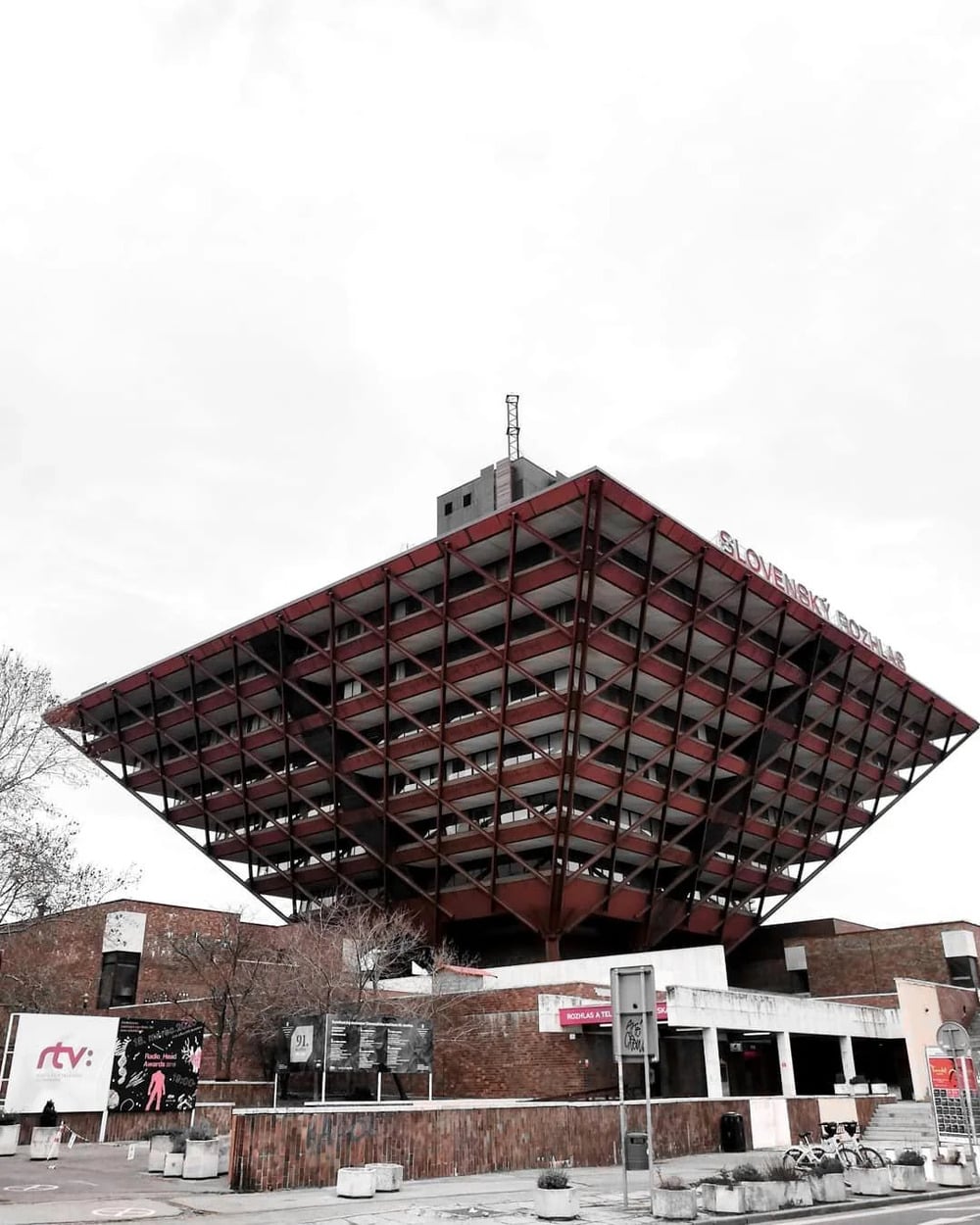 The inverted pyramid-shaped Slovak Radio building in Bratislava featuring a red steel exoskeleton.