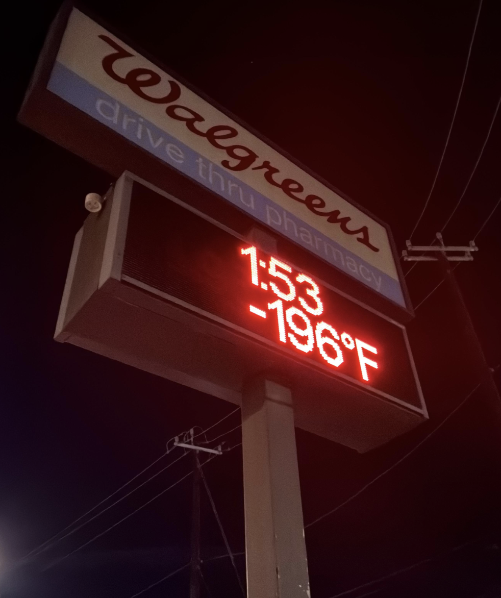 Walgreens drive-thru pharmacy sign displaying a time of 1:53 and a temperature of -196 degrees Fahrenheit.