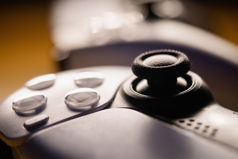 Close-up of a game controller joystick and buttons.