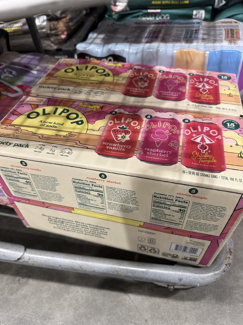 A 15-pack box of Olipop variety soda containing Strawberry Vanilla, Raspberry Sherbet, and Shirley Temple flavors.
