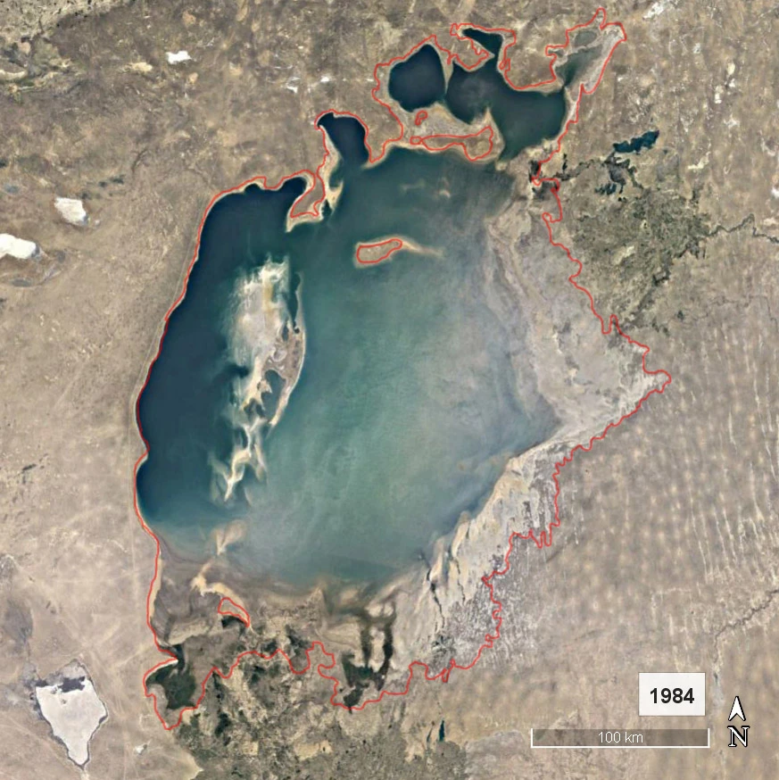 Satellite view of the Aral Sea in 1984, with a red outline marking its historical shoreline.