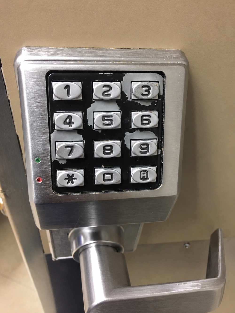 A numeric keypad with several buttons showing worn coating.