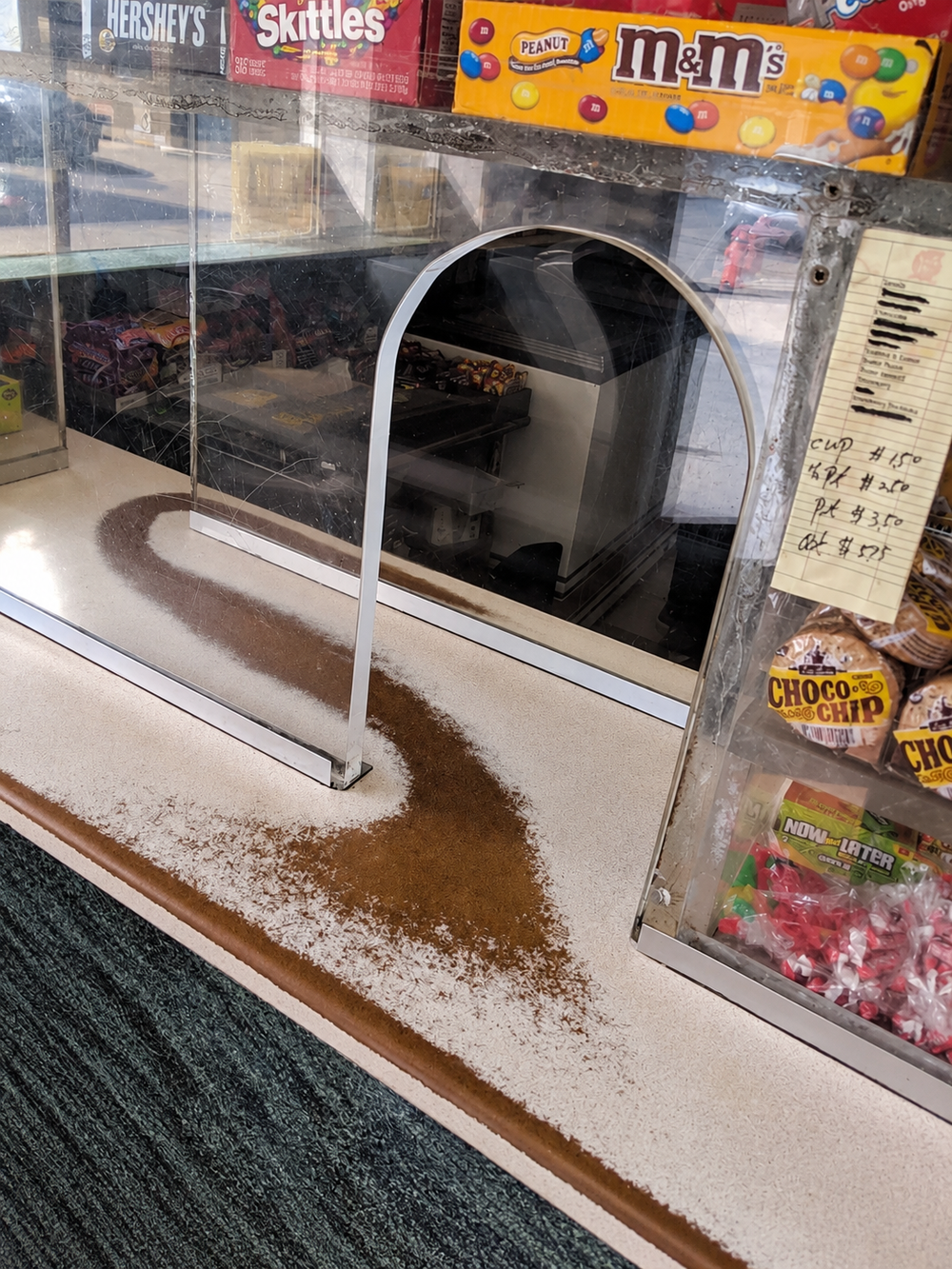 A checkout counter with a broad, darkened path worn into its surface.