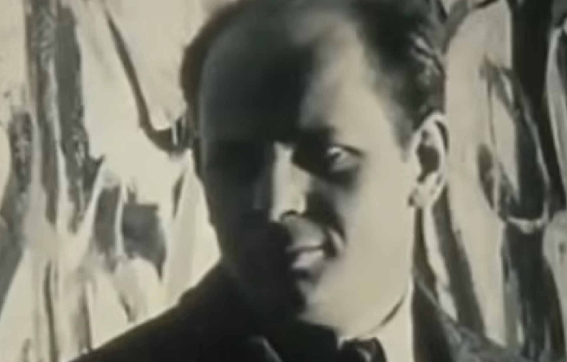 A black and white close-up portrait of Jackson Pollock.