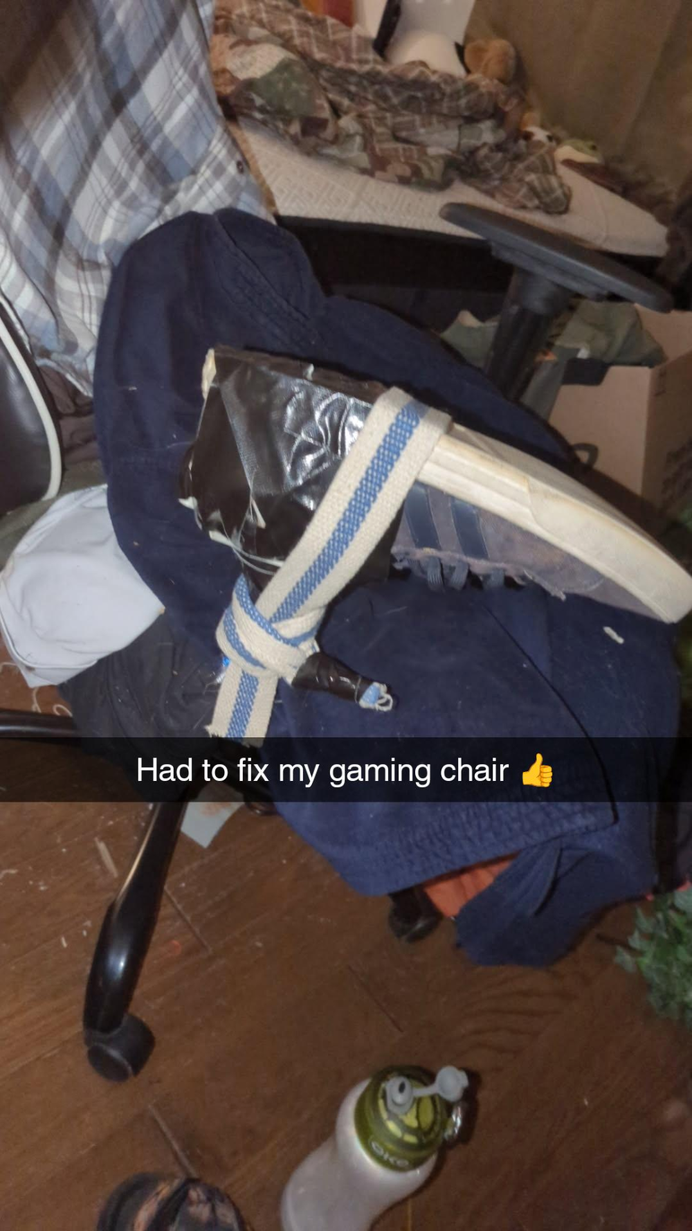 A shoe duct-taped and tied with a fabric strap to a gaming chair, with the text overlay: “Had to fix my gaming chair 👍”
