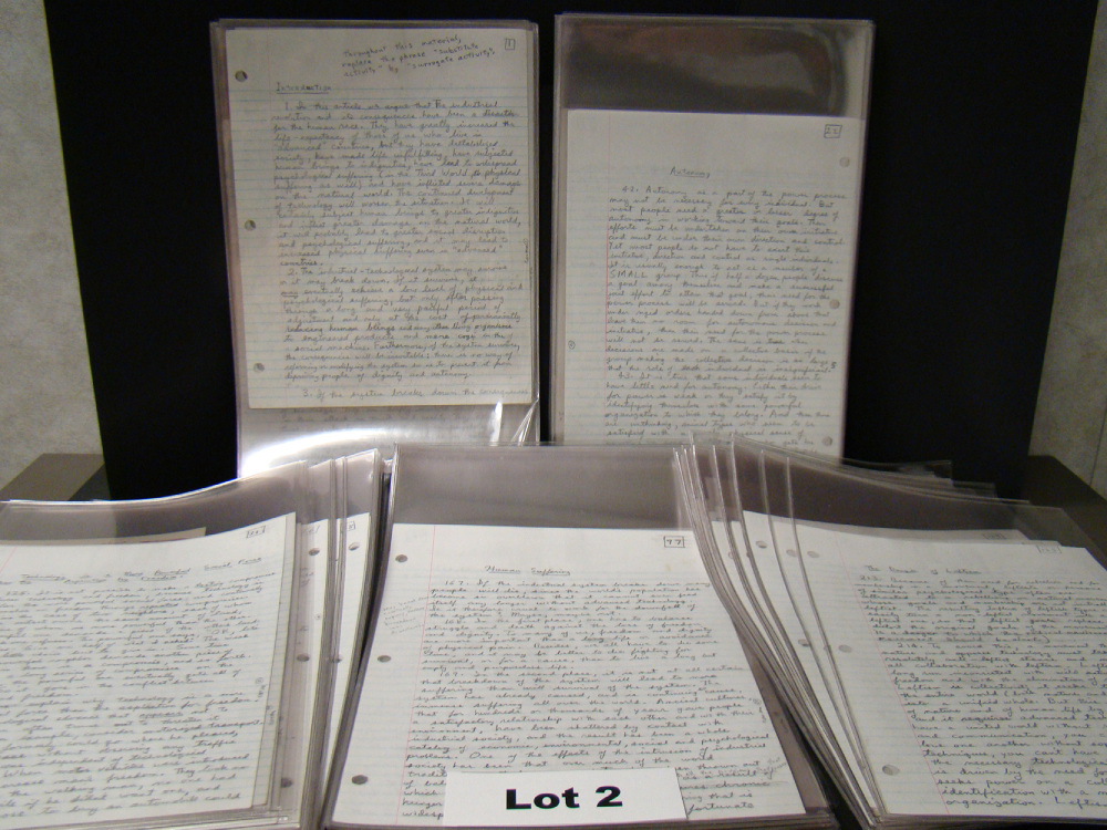 Several pages of handwritten text in plastic sleeves, organized on a display rack with a label reading “Lot 2” centered at the bottom.