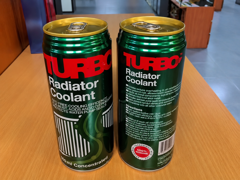 Two cans of Turbo Radiator Coolant side by side on a wooden surface, one showing the front label and the other showing instructions and product information.