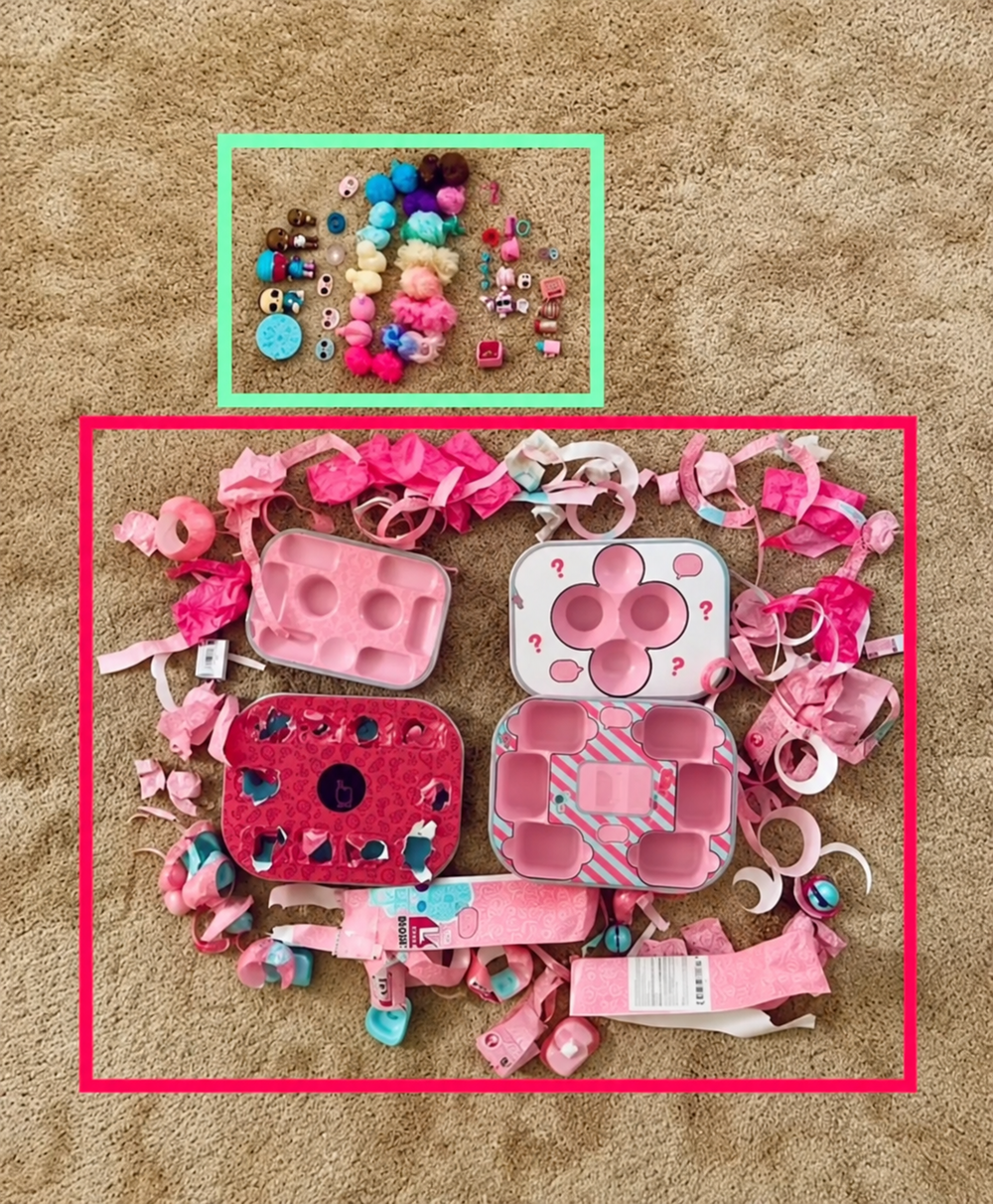 An L.O.L. Surprise toy set with small dolls, accessories, and pink packaging scraps spread out on a carpet.