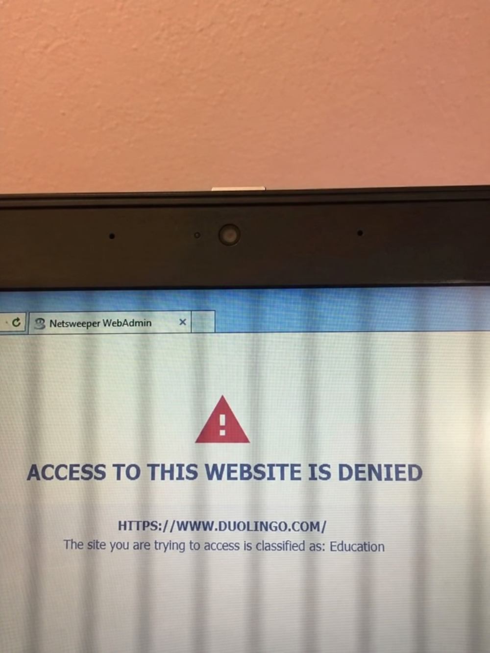 Computer screen showing a Netsweeper WebAdmin error page stating “Access to this website is denied” for duolingo.com, classified as Education.