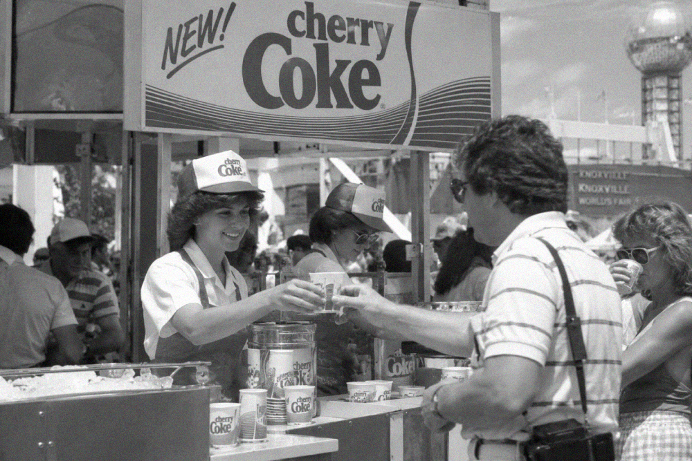 A Cherry Coke stand worker hands a drink to a customer at the 1982 Knoxville World’s Fair.