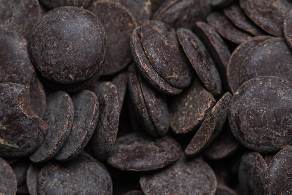 A pile of dark chocolate melting wafers.