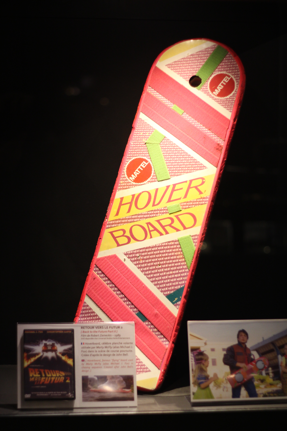 A Mattel Hoverboard prop from the movie Back to the Future Part II displayed with an information card and a film DVD cover.