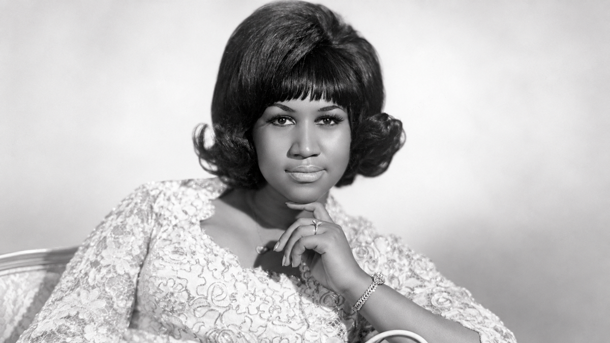 Portrait of Aretha Franklin with her hand resting under her chin.