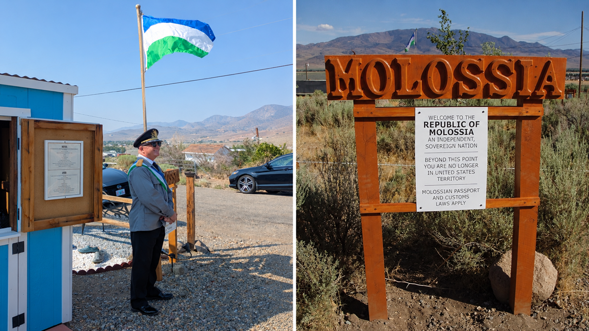 A man in uniform stands by a blue shack and flag; next to him, a wooden sign welcomes visitors to the Republic of Molossia, with mountains in the background.