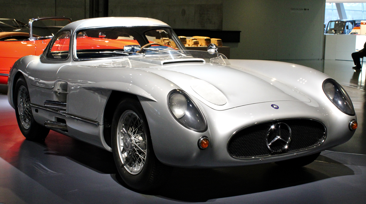 Silver Mercedes-Benz 300 SLR Uhlenhaut Coupé displayed in a museum.