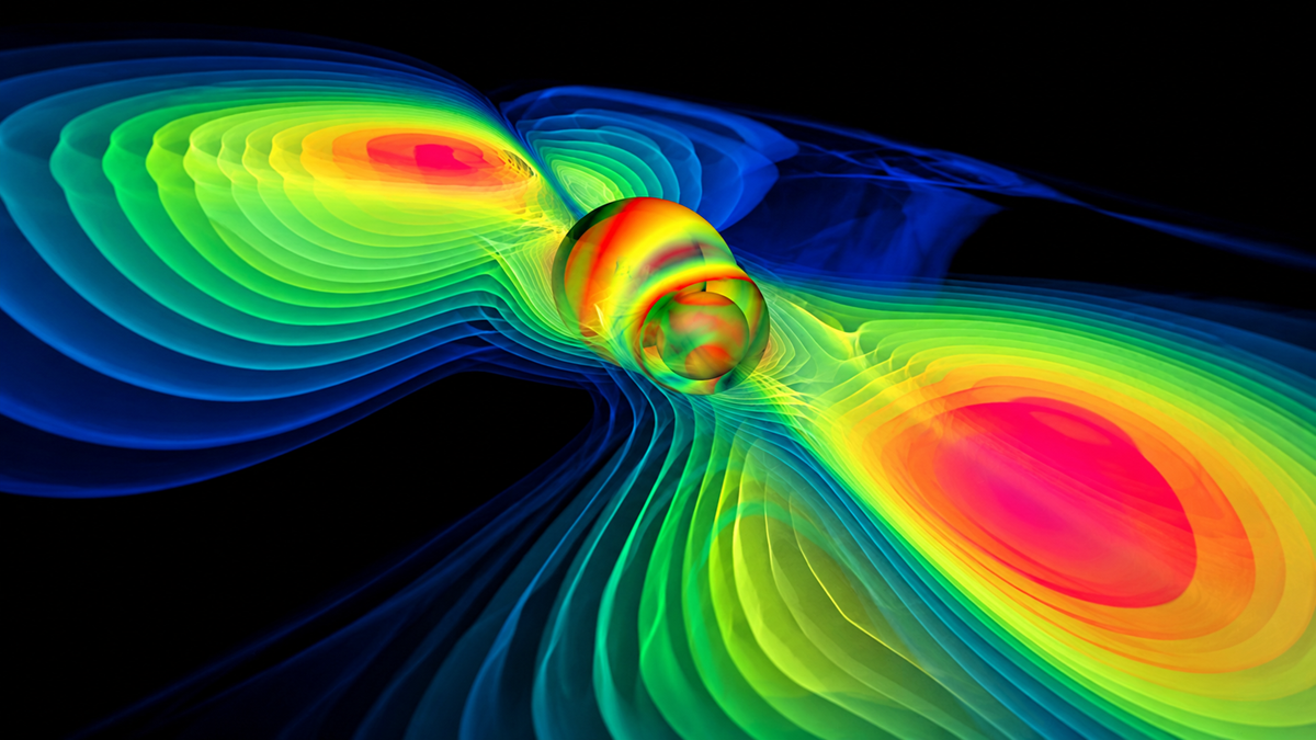 A scientific visualization of two orbiting objects surrounded by colorful, wavy magnetic field lines that radiate outward against a black background.