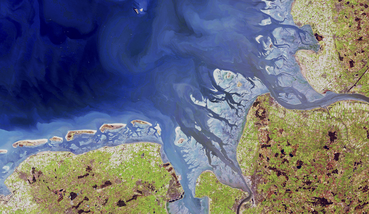 Satellite view of the Wadden Sea coast, showing barrier islands and tidal channels between the North Sea and the coastline of the Netherlands and Germany.