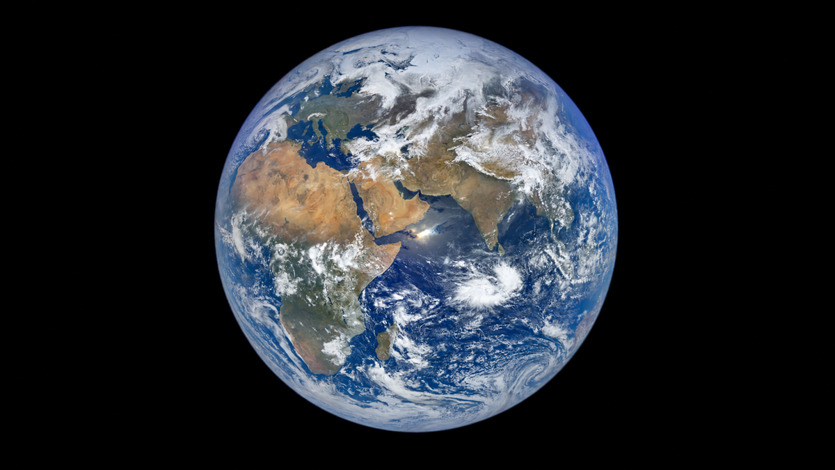 View of Earth from space, showing Africa, Europe, and the Middle East surrounded by clouds and blue ocean against a black background.