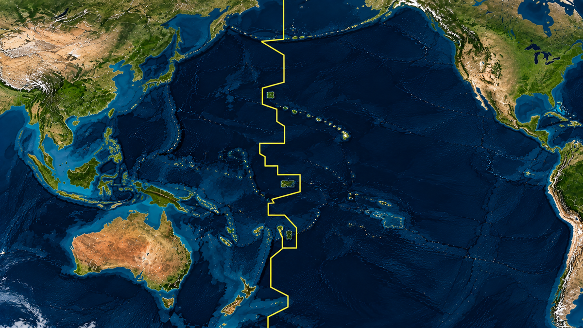 A map of the Pacific Ocean showing the jagged yellow line of the International Date Line running vertically between Asia and the Americas.