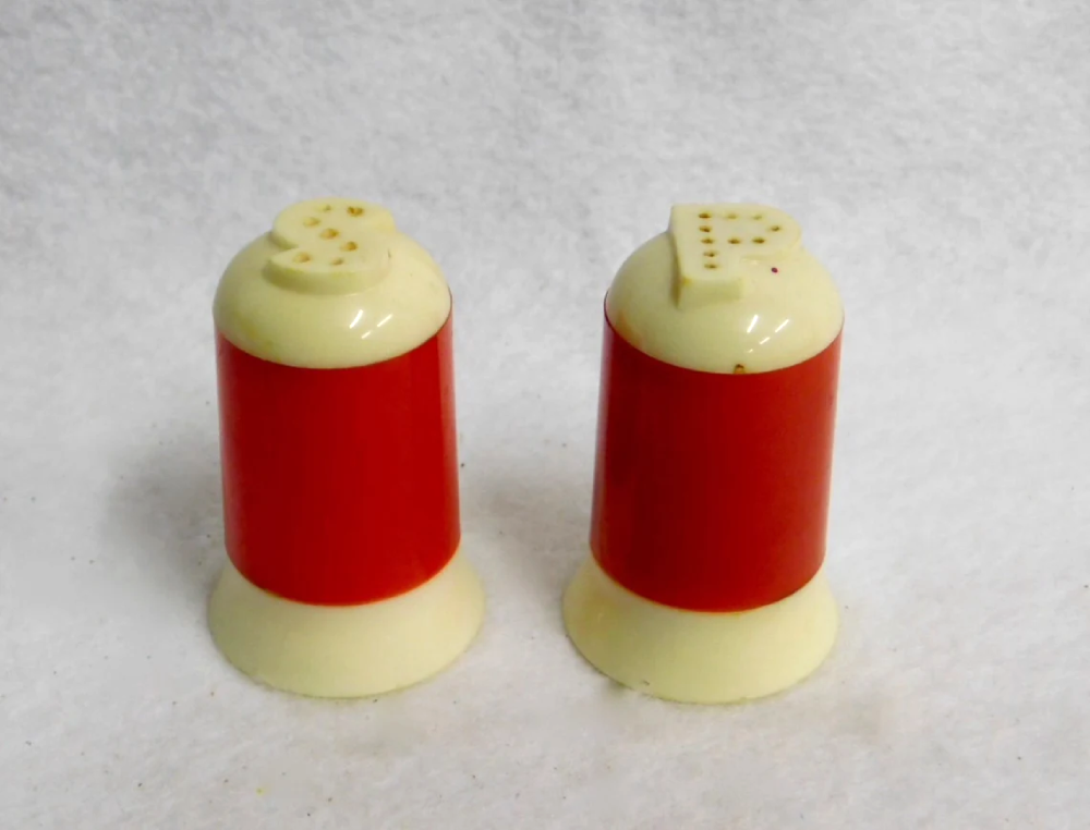 Vintage red and cream salt and pepper shakers with S and P shaped holes on top.