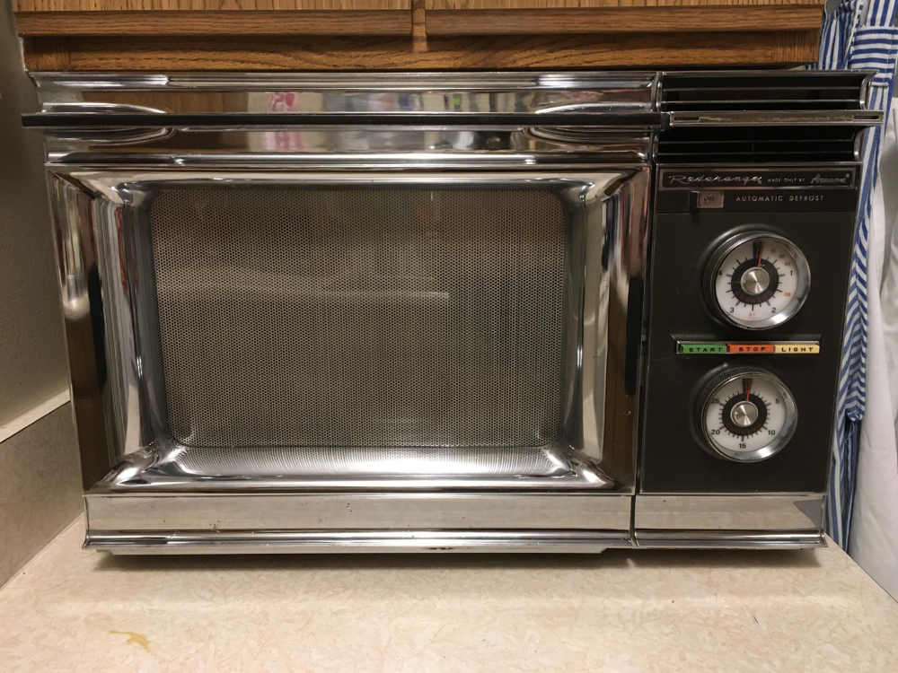 Vintage Amana Radarange microwave with a chrome finish, featuring two round analog timers and push-button controls on the right side.