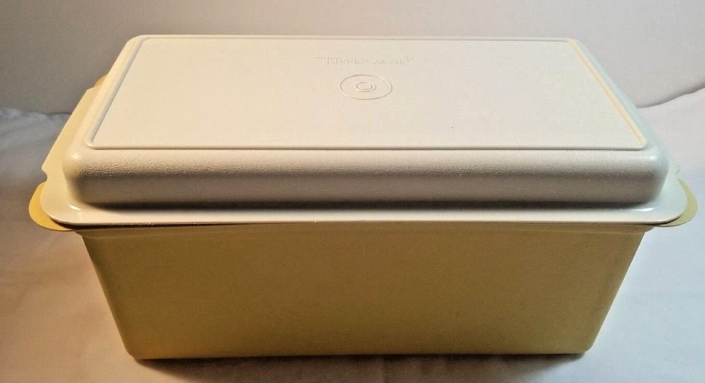 Yellow rectangular Tupperware storage container with a white lid.
