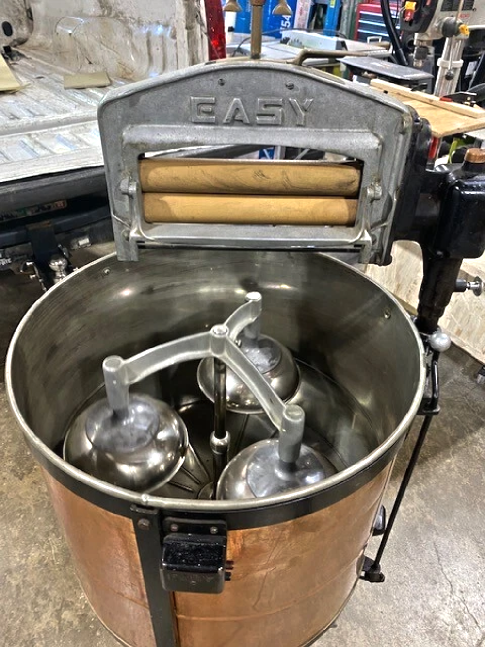 Vintage Easy brand copper wash tub with an agitator inside and a wringer attachment mounted on top.