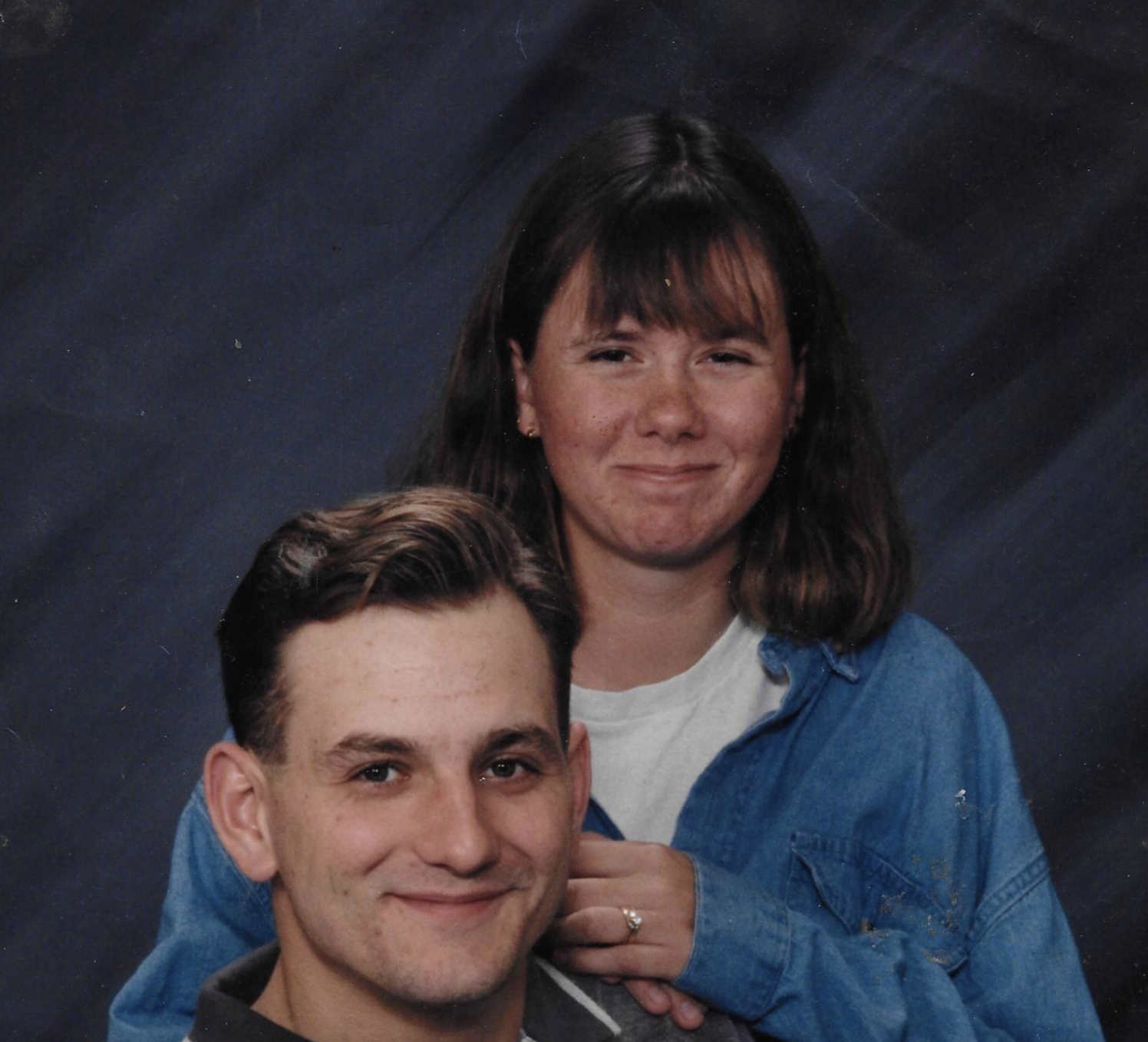 A young man and a young woman posing for a portrait together.