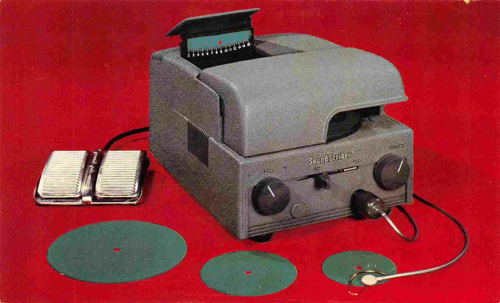 Vintage SoundScriber desktop dictation machine with a foot pedal and three flat recording discs on a red background.