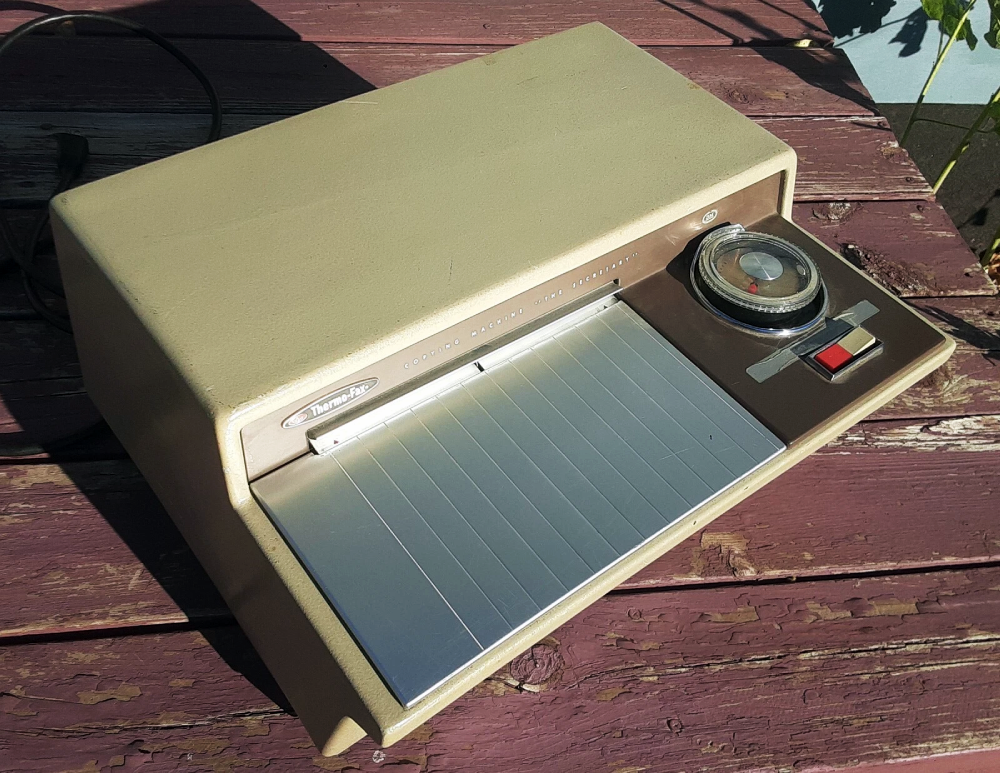 Vintage Thermo-Fax “The Secretary” copying machine on a wooden surface.