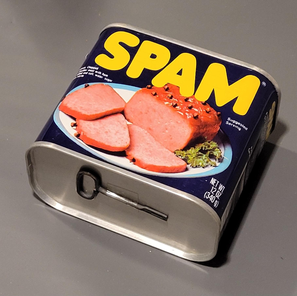 A can of SPAM luncheon meat with a metal key opener on the front.