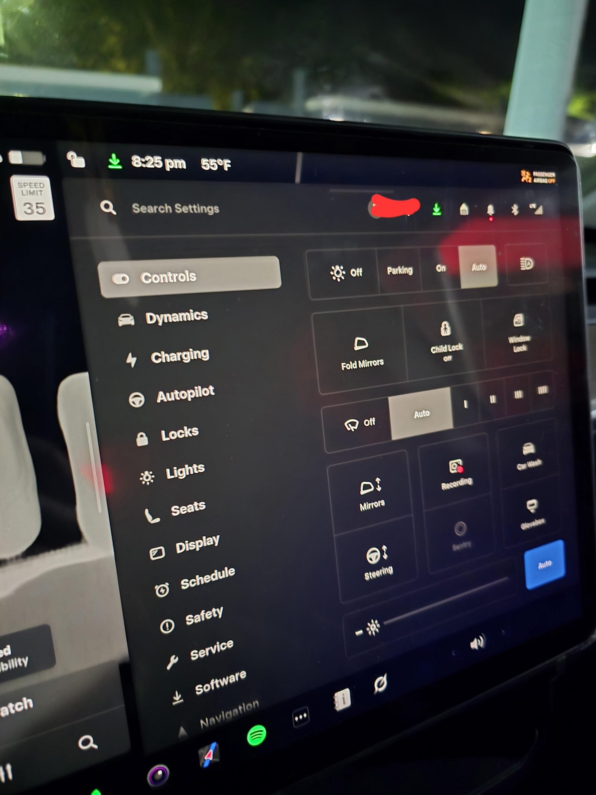 A Tesla vehicle touchscreen displaying the Controls menu, including settings for mirrors, locks, lights, and charging.