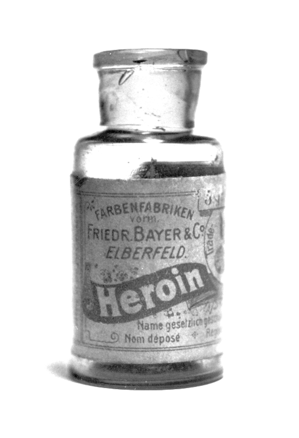 A small glass medicinal bottle with a label reading “Farbenfabriken vorm. Friedr. Bayer & Co. Elberfeld” and the word “Heroin” in large print.