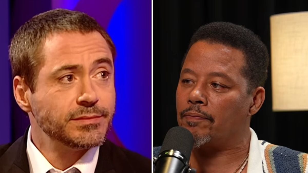 Two men are shown side by side. The man on the left has short brown hair and a trimmed beard, wearing a suit. The man on the right has short dark hair, a mustache, and goatee, speaking into a microphone.