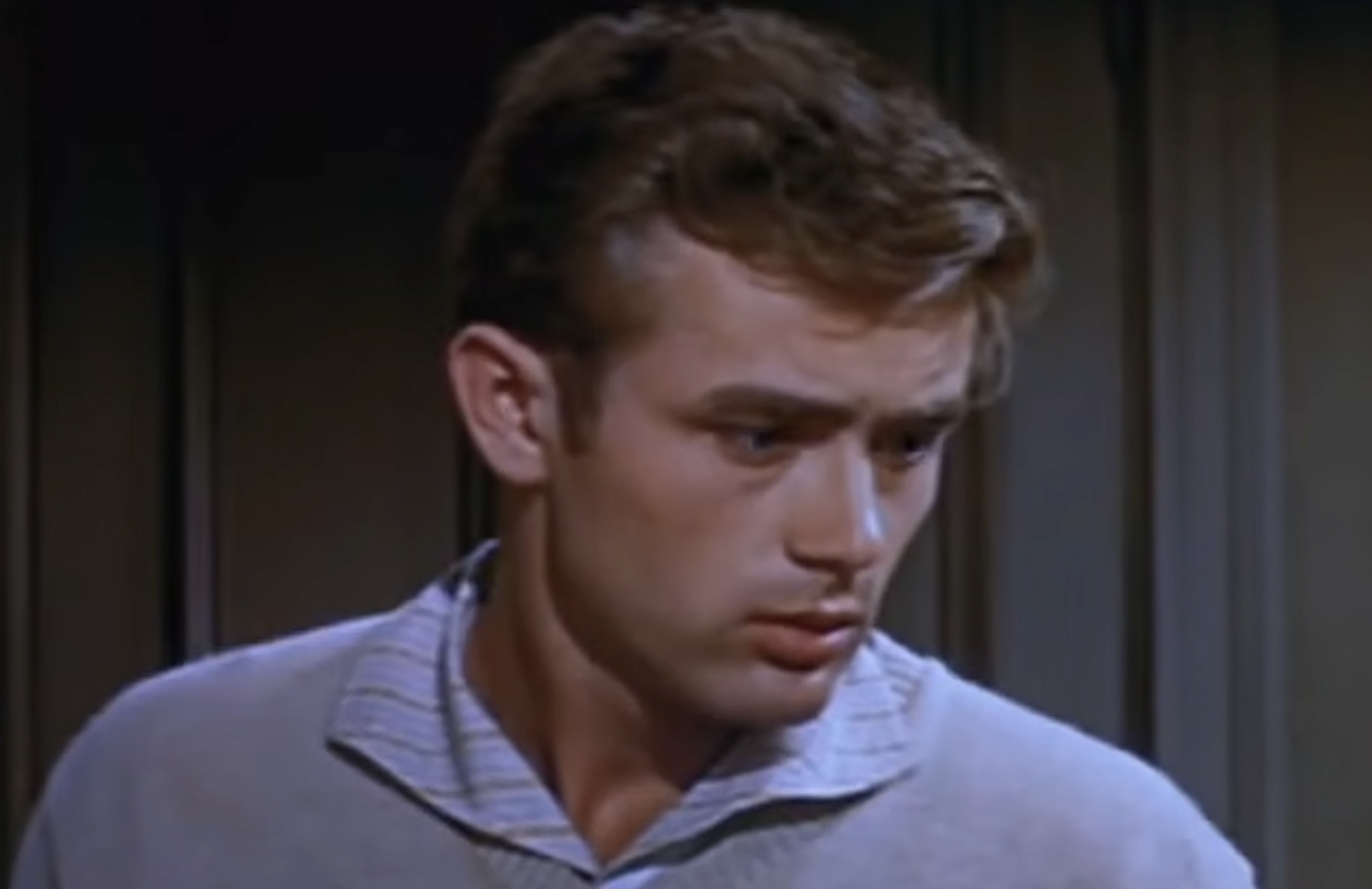 A close-up of James Dean looking off-camera with a concerned expression.
