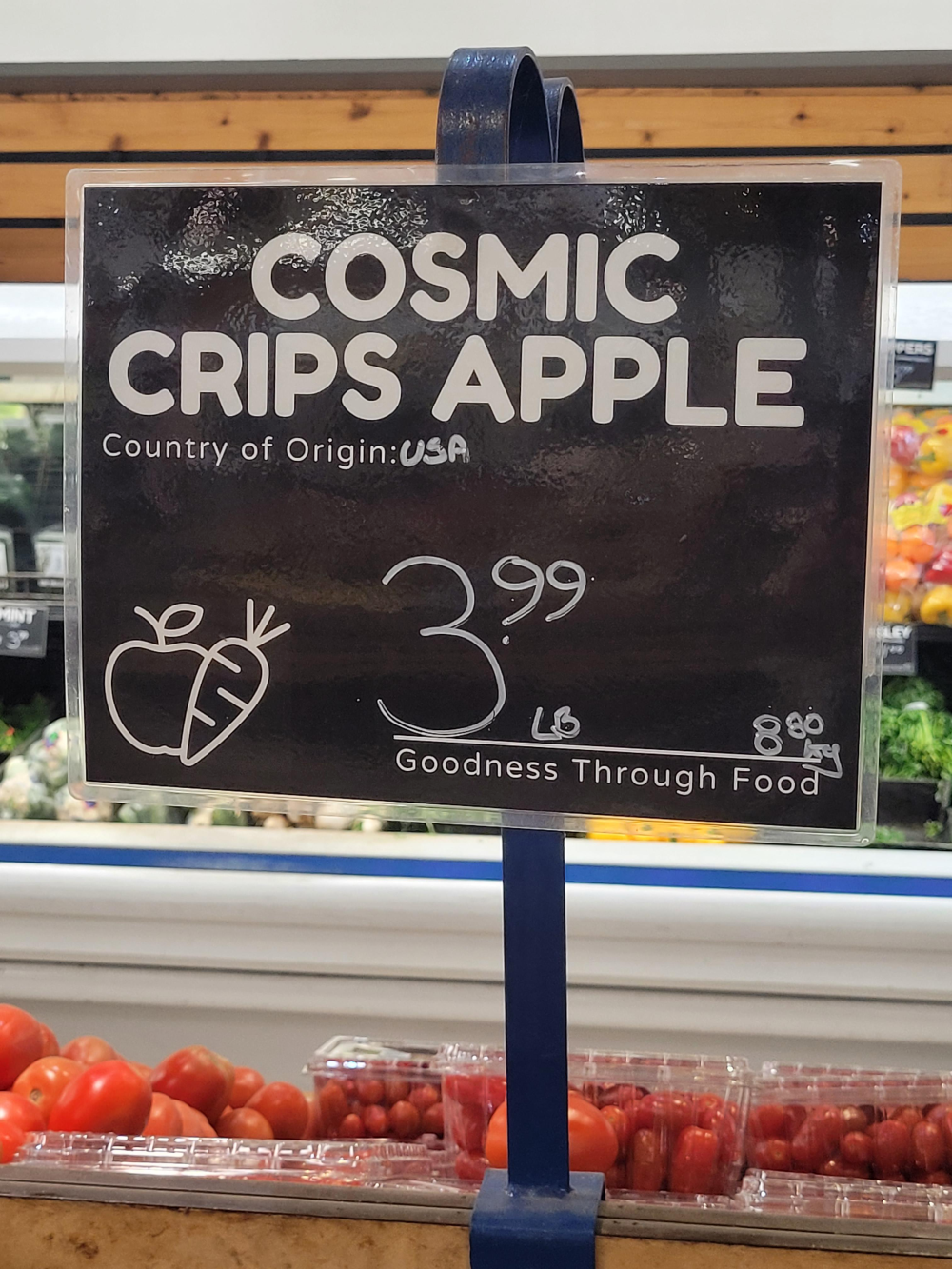 Grocery store sign for Cosmic Crips apples priced at $3.99 per pound, with “Country of Origin: USA” noted.