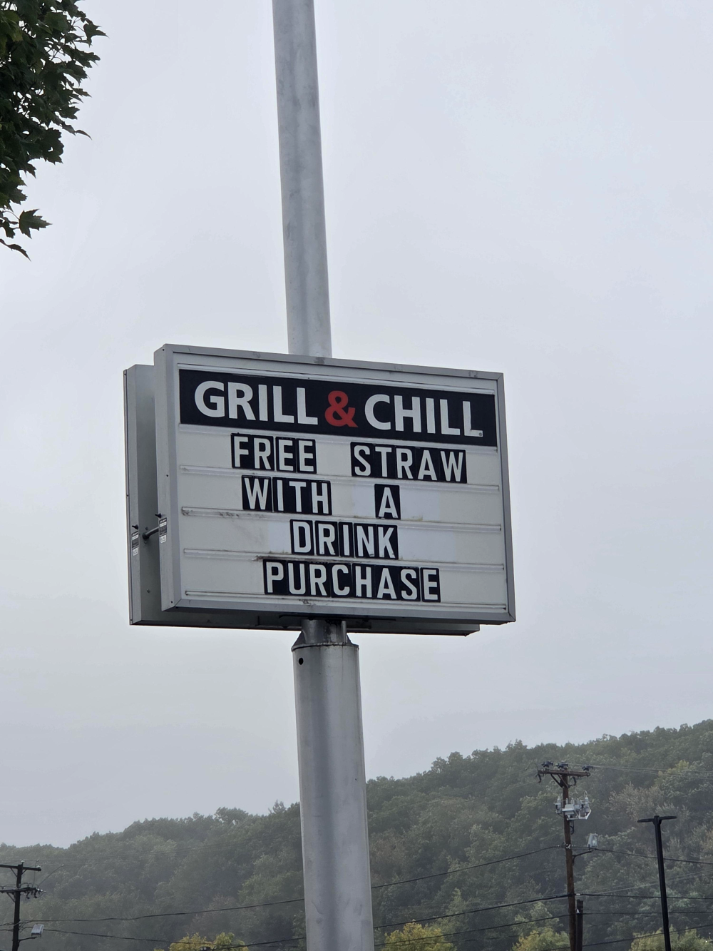 Grill & Chill sign reading “FREE STRAW WITH A DRINK PURCHASE.”