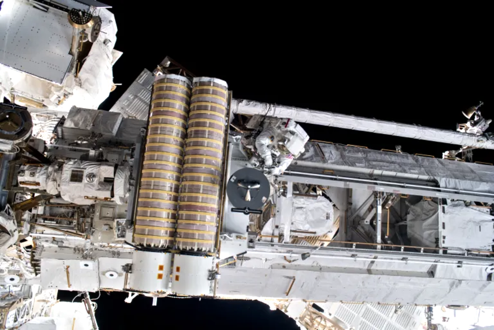 An astronaut performs a spacewalk on the exterior of the International Space Station.